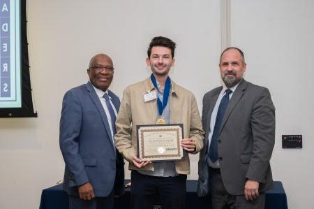 Brandon Berube accepting a certificate of achievement